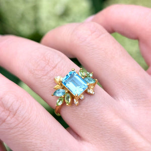Blooming 1CT Emerald Cut Blue Gemstone Leafy Halo Engagement Ring