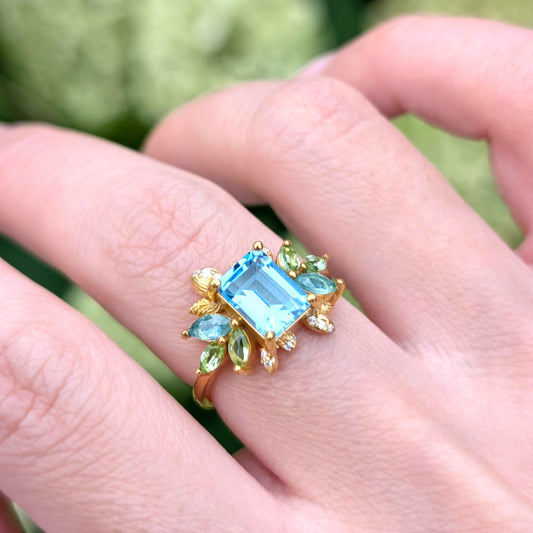 Blooming 1CT Emerald Cut Blue Gemstone Leafy Halo Engagement Ring
